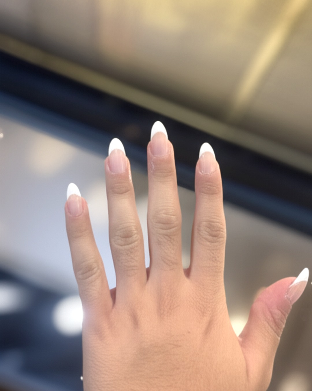 White French tips on long almond nails