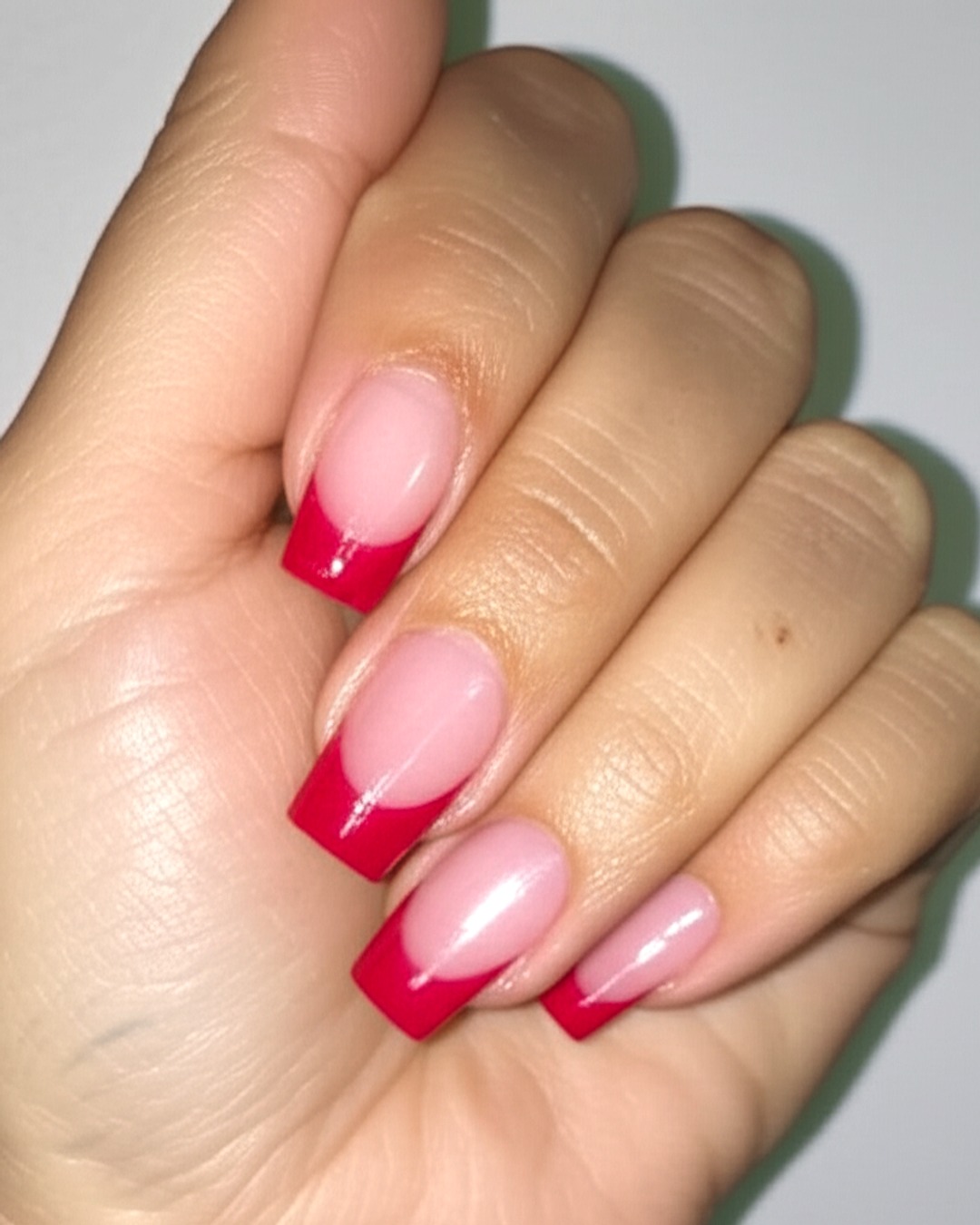 Bold red French tips on long coffin nails