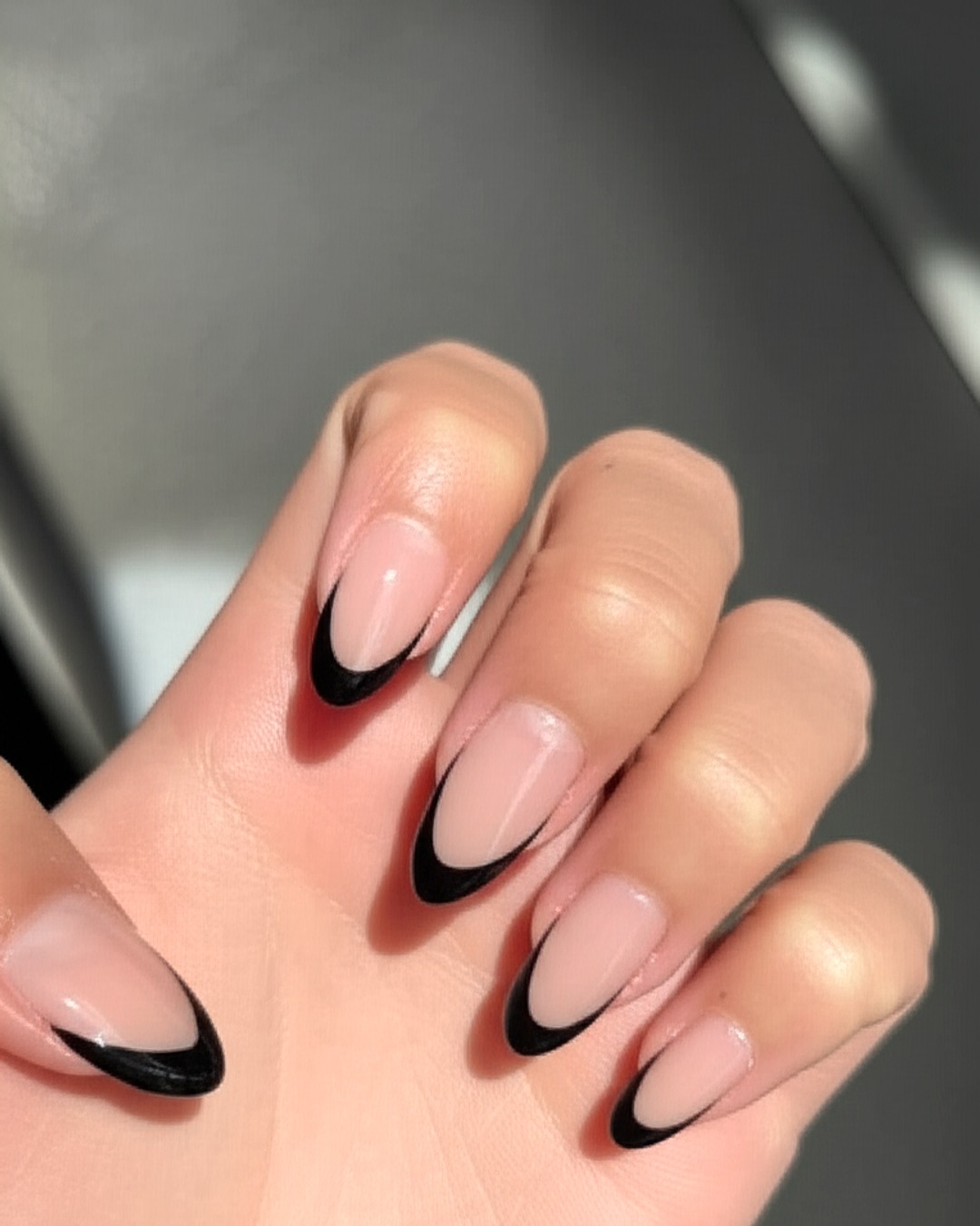 Black French tips on almond nails